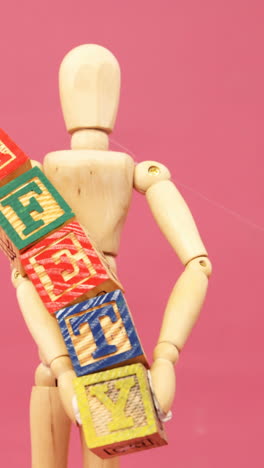 figurine holding alphabet toy block