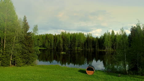 Vista-Aérea-Baja-Del-Lago-En-Medio-Del-Bosque-Rodeado-De-Pinos