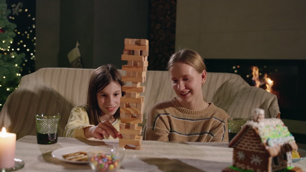 Girls Playing a Stacking Blocks Game at Christmas