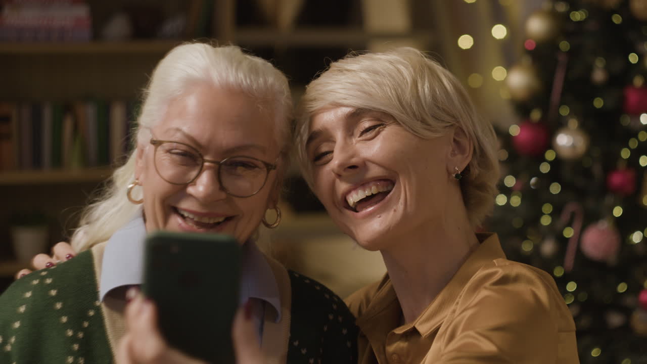 Women Taking a Selfie in Front of a Christmas Tree