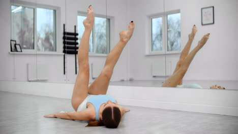 woman stretching legs in a dance studio