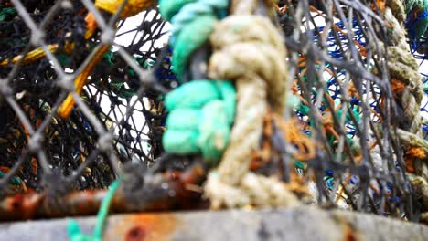 stacked empty fisheries industry lobster net baskets closeup dolly right