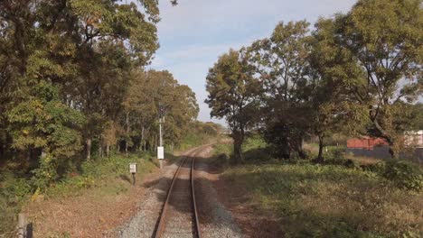 view of the railway track road while on moving train travels fast,the length of the railway track, japan public train transportation