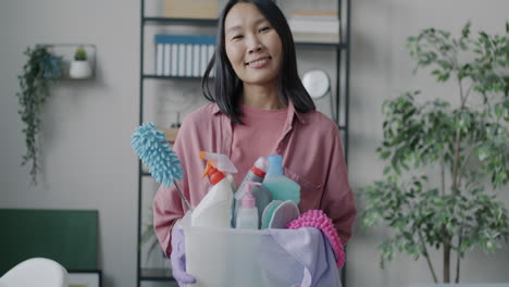 woman holding cleaning supplies