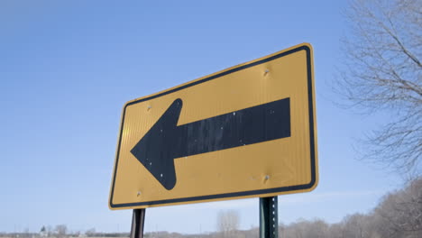 Road-Sign-Left-Arrow-in-Country-Pan-Down-from-Sky