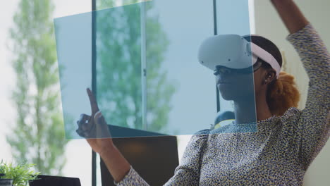 Woman-Looking-At-Projected-Screen-Sitting-At-Desk-Wearing-VR-Headset-Interacting-With-AR-Technology