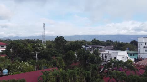 Coastal-sea-view-of-trees,-buildings,-ocean-and-boats-in-Philippines