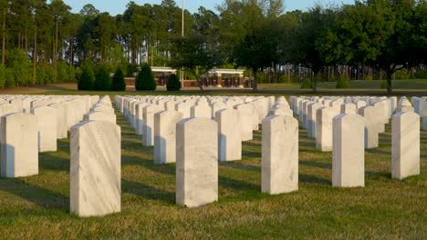 medium shot of tombstones in the sunlight at fort jackson national cemetery at sunset