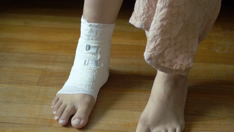 Woman-with-bandaged-foot-close-up-,