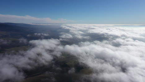 aerial view of mountains above clouds france massif central auvergne sunny day