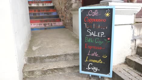 outdoor cafe menu sign with steps