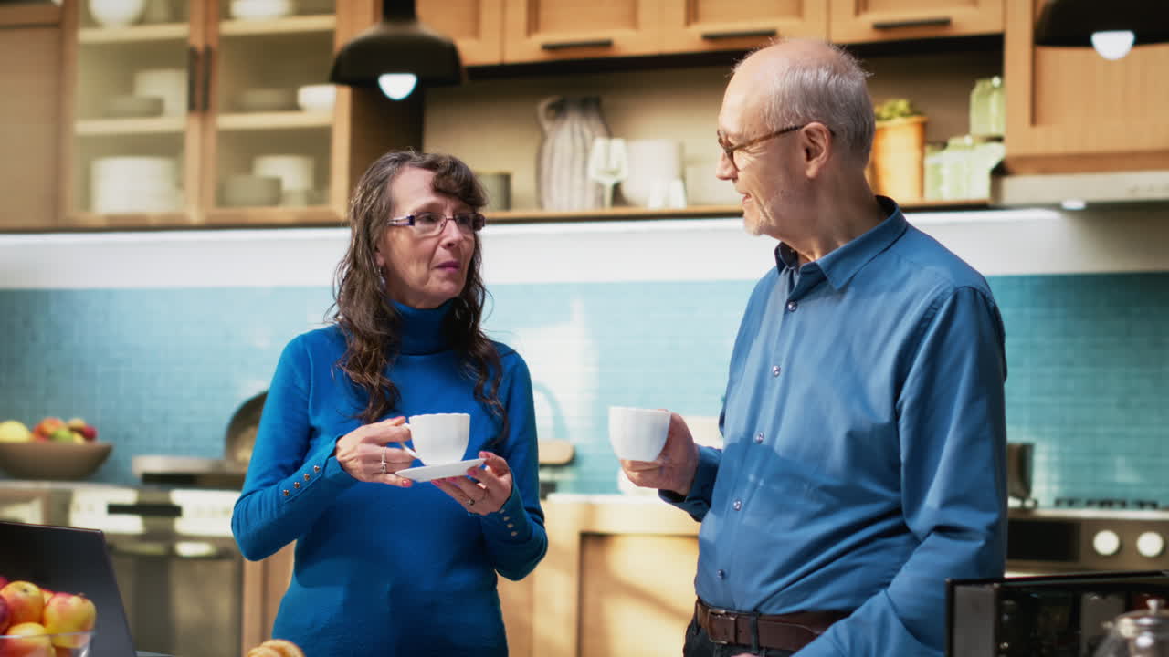 Portrait of aged people in apartment kitchen enjoy calm moment with coffee cup