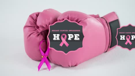 animation of breast cancer awareness text over pink boxing gloves