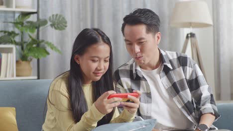 father and daughter enjoying time together on smartphone