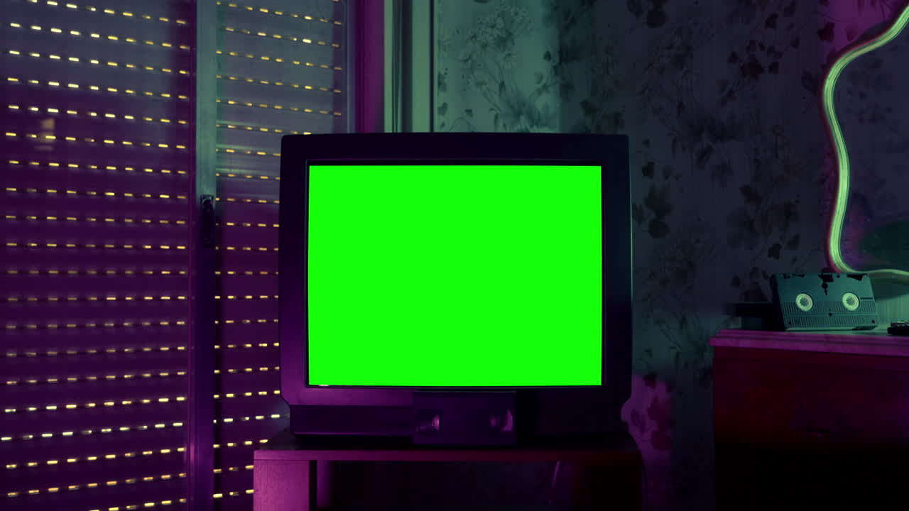Retro CRT Television with Green Screen in Dark Room