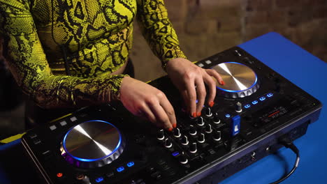 woman with headphones djing at the disco