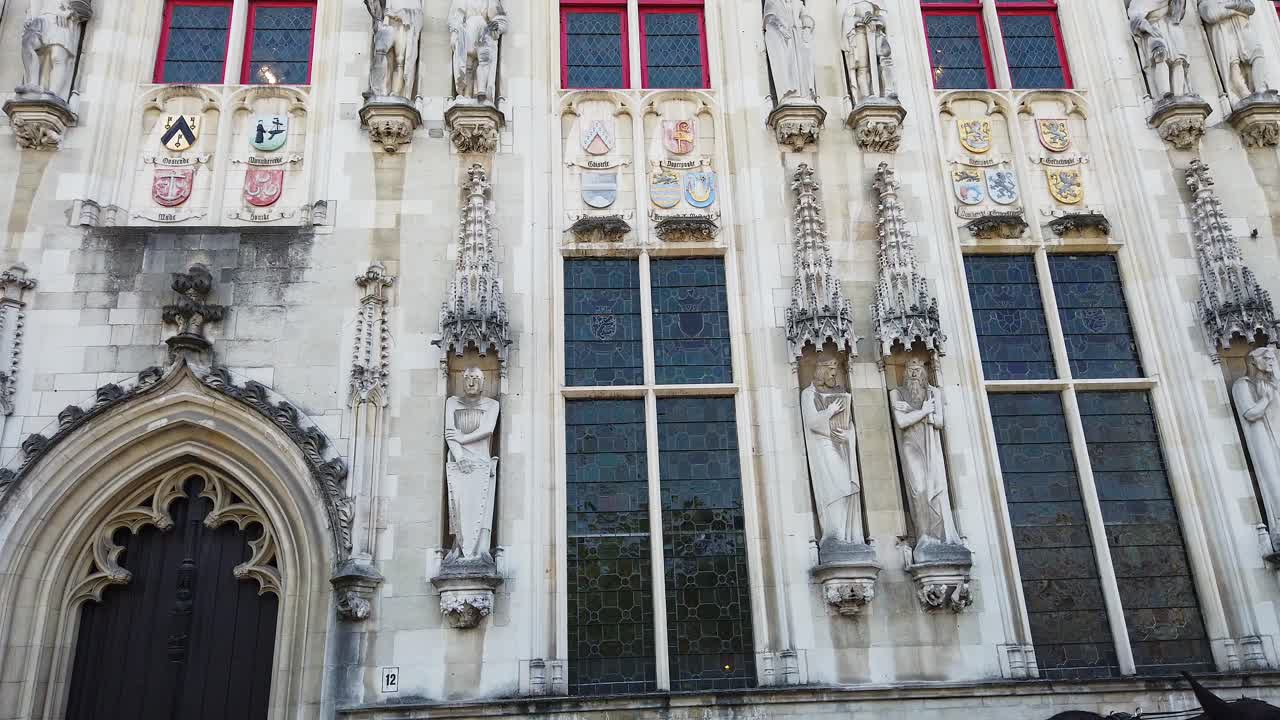 Brugge, Belgium - September 21, 2021: Horse drawn carriage in front of the City Hall of Bruges