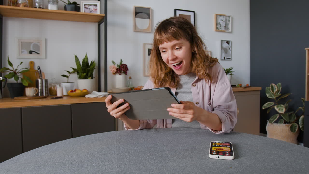 Woman at home using tablet and phone