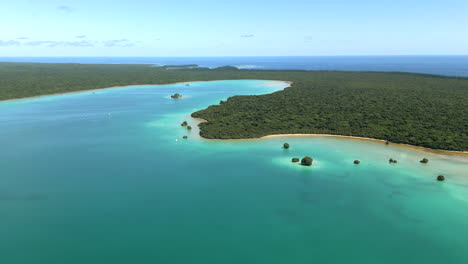 Upi-Bay-with-small-pirogue-sailboats-taking-tourists-to-remote-beaches-on-the-Isle-of-Pines