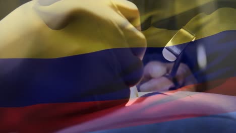 Animation-of-flag-of-colombia-waving-over-surgeons-in-operating-theatre