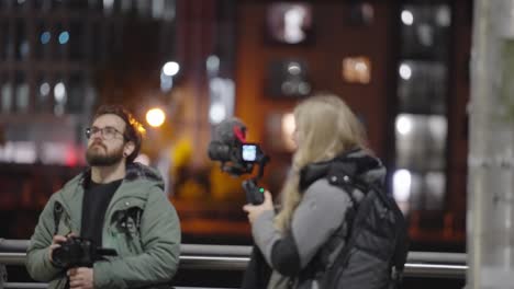 media camera equipment, behind the scenes shoot, urban evening scenery