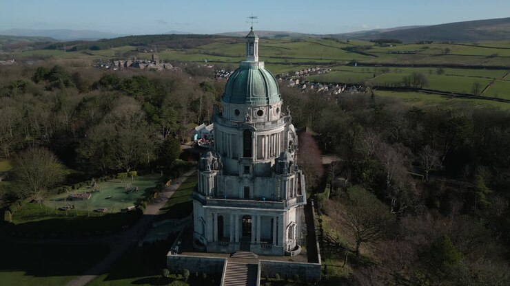 Ashton Memorial monument in Williamson Park Lancaster UK pan down westerly aspect revealing green fields and M6 motorway