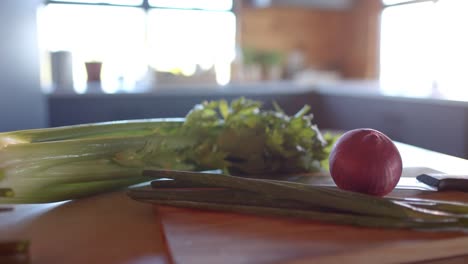 organic vegetables on countertop in sunny kitchen, slow motion