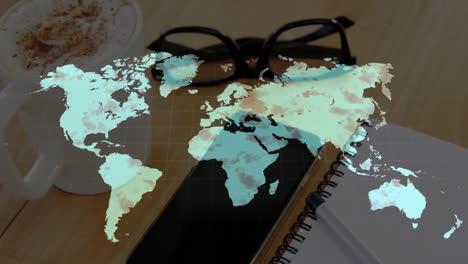 wooden desk showing coffee mug, eyeglasses, notebook under world map overlay hovering above scene