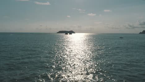 Cinematic-Drone-aerial-flying-over-the-calm-sea-during-summer