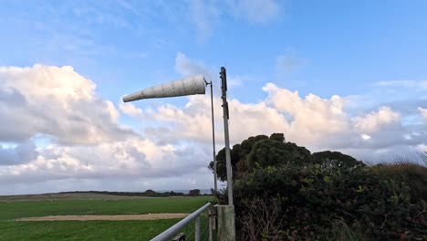 windsock swaying in the breeze, scenic landscape