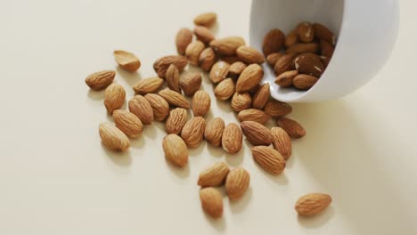 video of almonds in a bowl on white background