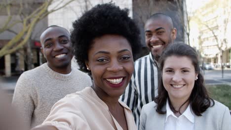 group of cheerful people talking during video call