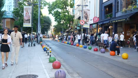 busy street scene with people walking, shops, and street vendors