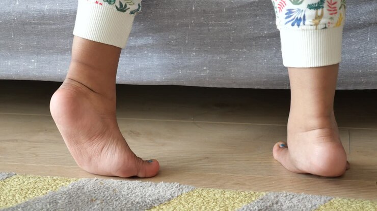 Low angle view of a child walking on tiptoes