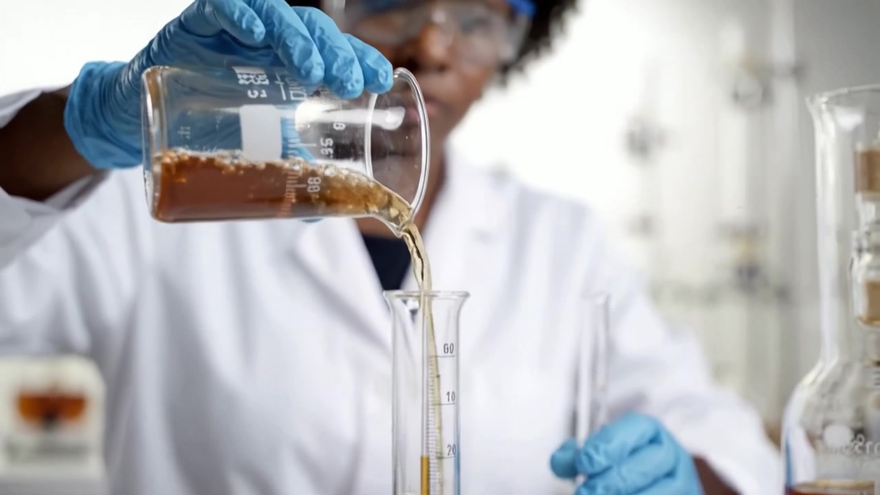 A skilled chemist conducts an experiment, carefully measuring and mixing substances in a laboratory setting, showcasing precise techniques and scientific exploration.