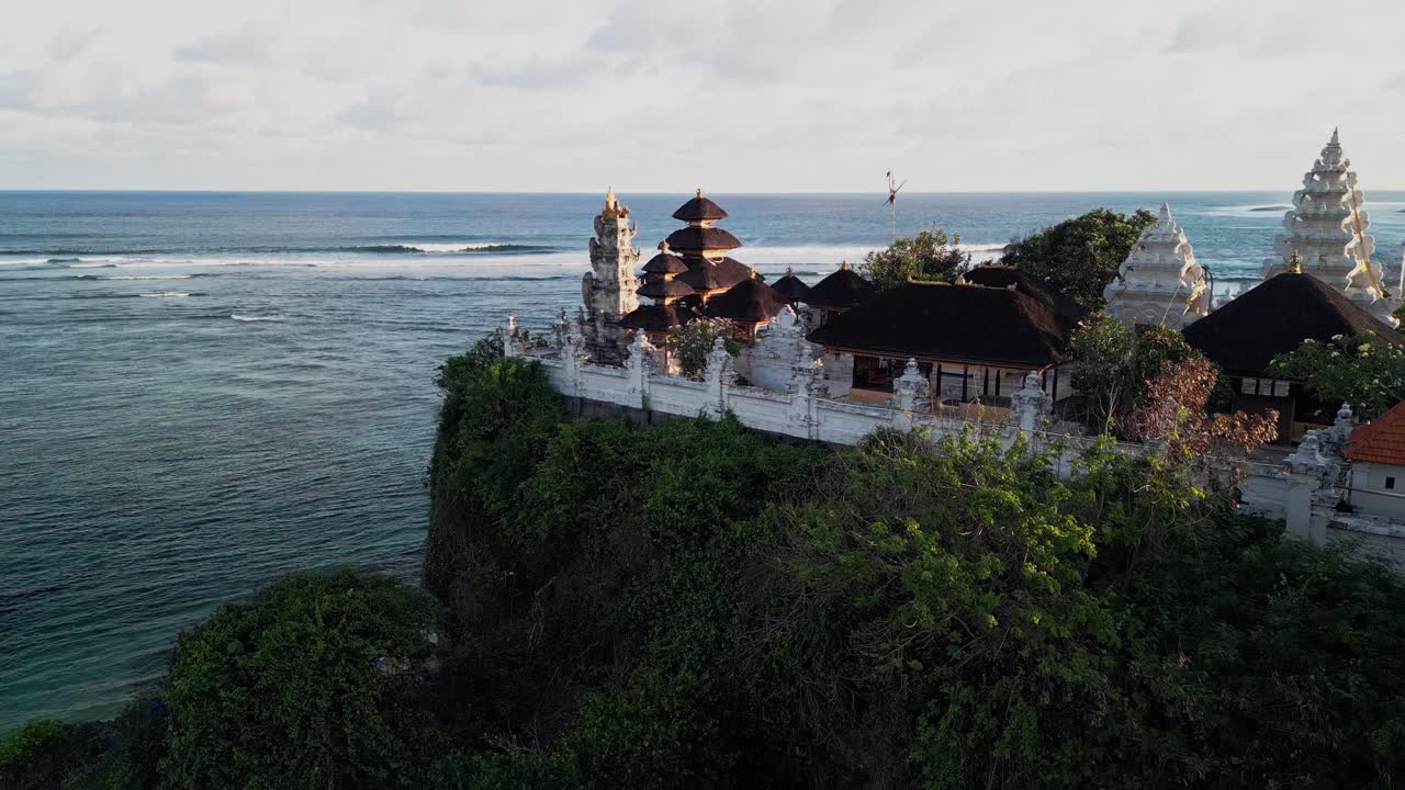 Drone footage shows the sacred Uluwatu temple beside the ocean, surrounded by cliffs and tropical scenery. Its timeless architecture reflects Bali’s spiritual heart and connection with the sea