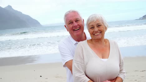 senior couple embracing each other on the beach