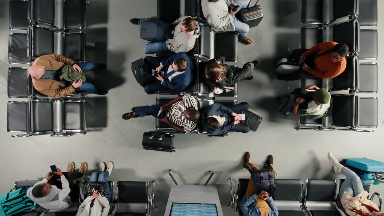 Walking, top down view and multiethnic travelers in busy airport departure terminal