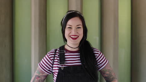 portrait of young woman with tattoos smiling confident happy