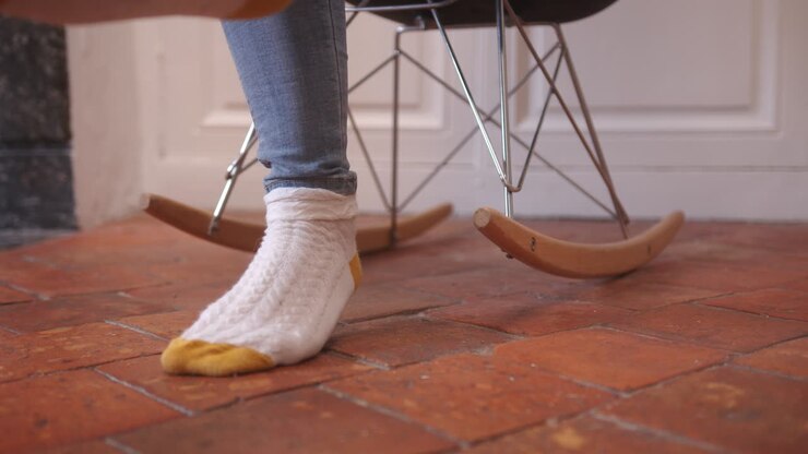 Swinging on a rocking chair, lazy days in retirement home, low angle