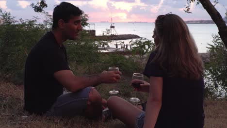 couple enjoying sunset drinks at the beach