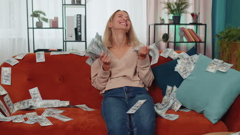 successful happy rich business woman counting money cheering up with high profits, lottery game win