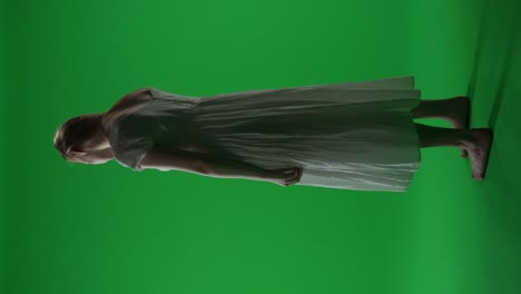 woman in white dress against green screen