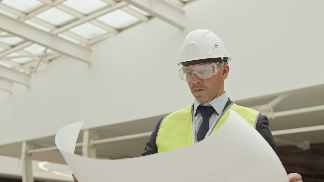 Builder Looking Carefully at Project Paper