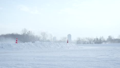 snowy track with fog and cones