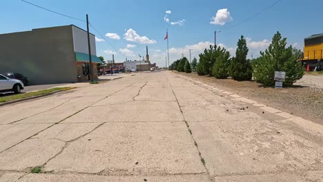 pov - driving on a hickory street near the rail yard and along the train tracks on the edge of small midwestern town;hometown