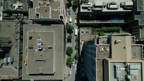 4k cinematic urban drone footage of an aerial view flying over buildings and boulevards in the middle of downtown montreal, quebec on a sunny day looking down from a bird's point of view
