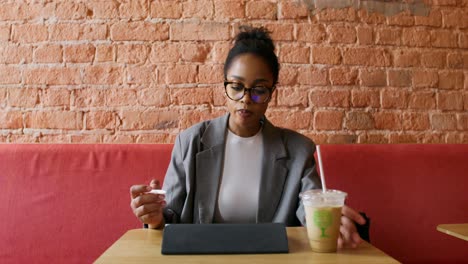 woman working on tablet in coffee shop