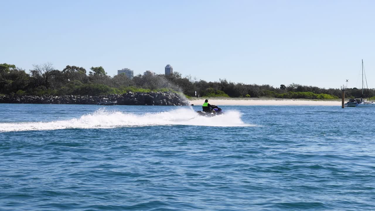 해안선을 따라 속도를 내는 제트 스키 라이더