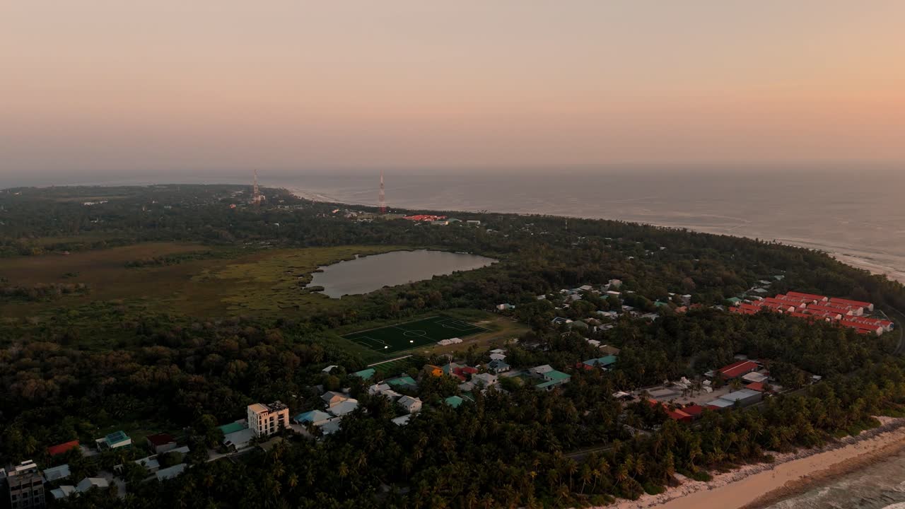Aerial footage captures the lush, unspoiled landscape of Fuvahmulah as the sun dips below the horizon.